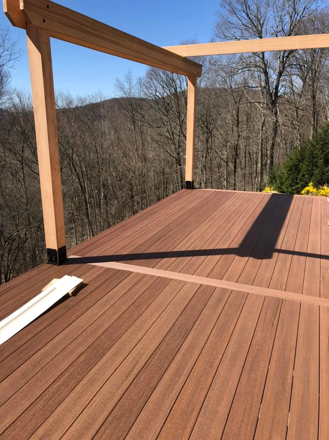 Deck construction with wood posts and a composite surface