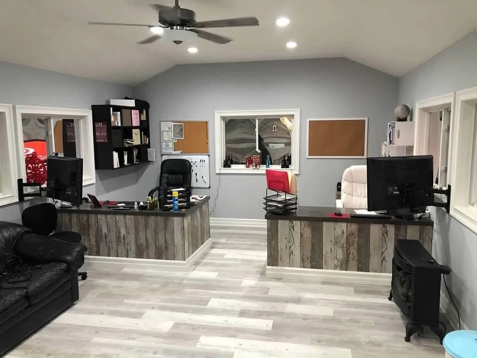 Office after renovation with gray walls, new flooring and organized workstations