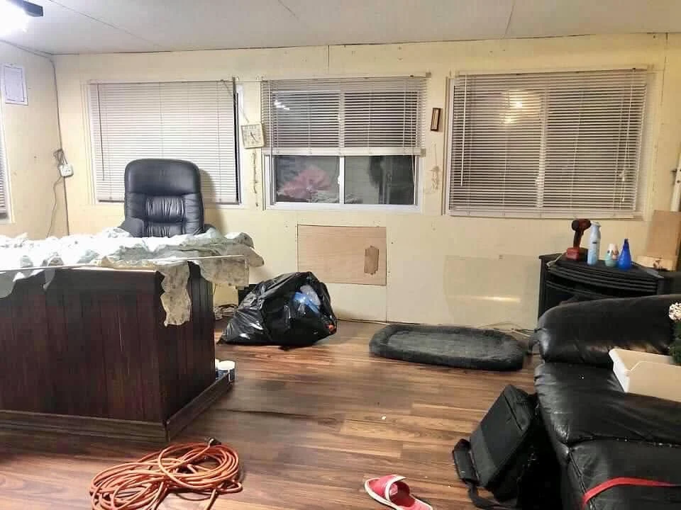 Office before renovation with unfinished walls and dark flooring